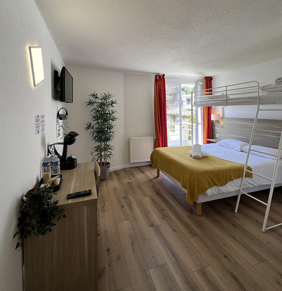 Hotel room with bunk bed and balcony.